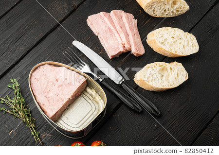 Canned ham slices sandwich, on black wooden table background 82850412