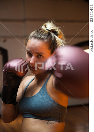 Young sportswoman doing kickboxing Young sportswoman doing kickboxing 82851498