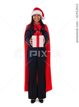 Santa woman standing holding gift box with smile, full lenght.Isolated on white background. Young mixed race Asian, Caucasian model. 82852622