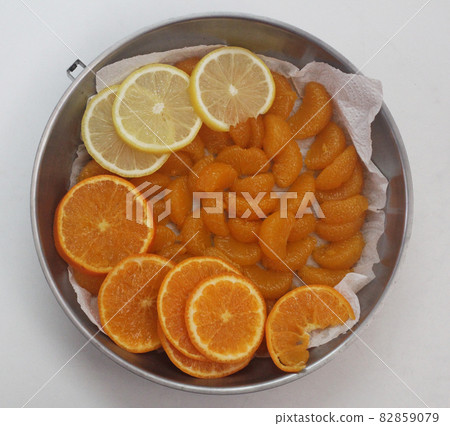 High angle view of organic freshness slide lemon and orange on stainless plate at home kitchen, fruit advserting backgrounds High angle view of organic freshness slide lemon and orange on stainless plate at home kitchen, fruit advserting backgrounds 82859079