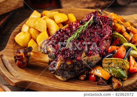 Lamb knuckle with lingonberry sauce and vegetables 82862072