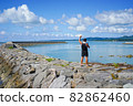 An adult man who guts poses at the breakwater of Uminchu Park on Kohama Island, Okinawa Prefecture 82862460