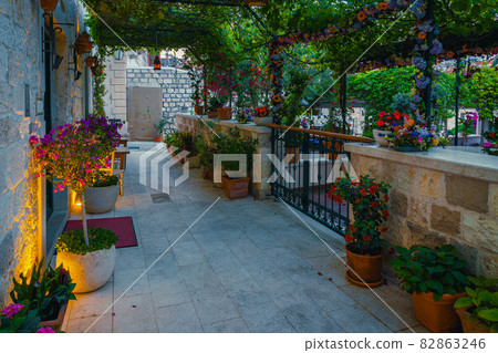 Cozy narrow street and garden decorated with colorful flowers Cozy narrow street and garden decorated with colorful flowers 82863246