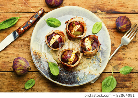 Figs baked in bacon with cheese,top view 82864091