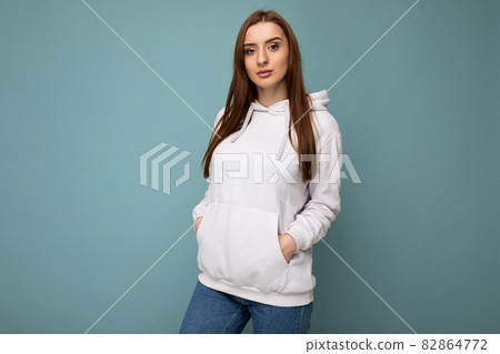 Young beautiful brunette woman with sincere emotions isolated on background wall with copy space Young beautiful brunette woman with sincere emotions isolated on background wall with copy space 82864772