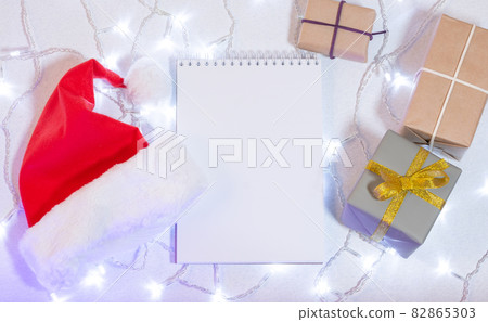 Christmas mockup card with red hat Top view Christmas mockup card with red hat Top view 82865303