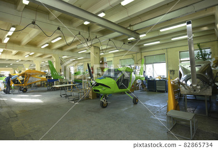 The assembly shop interior. Light plane, worker assembling a body aircraft The assembly shop interior. Light plane, worker assembling a body aircraft 82865734
