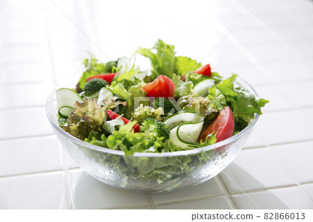 Housewife in the kitchen making salad 82866013