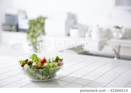 Housewife in the kitchen making salad 82866014