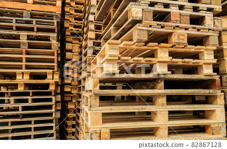 Stack of wooden pallet. Industrial wood pallet at factory warehouse. Cargo and shipping concept. Sustainability of supply chains. Eco-friendly nature and sustainable properties. Renewable wood pallet. 82867128