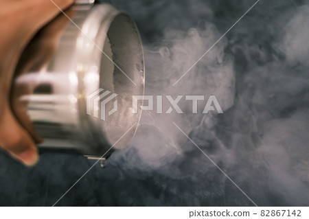 Spill liquid nitrogen from a metal container Spill liquid nitrogen from a metal container 82867142