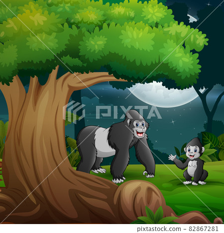 Night forest with a mother gorilla and her cub under the tree 82867281