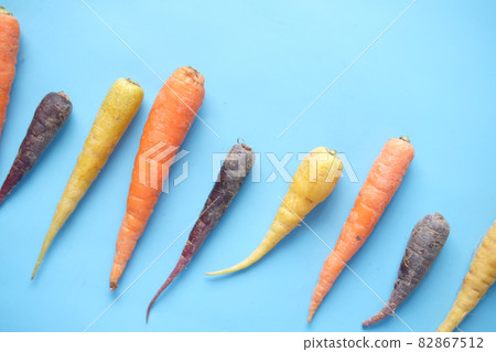 mixed colorful carrot on blue background  82867512