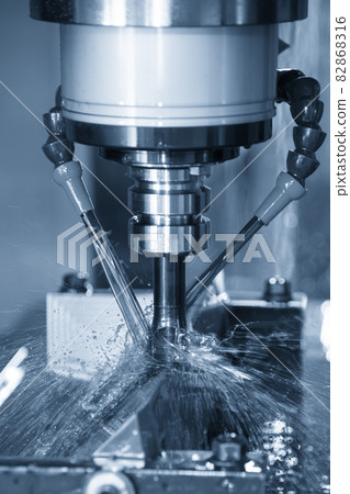 The vertical scene CNC milling machine cutting the mold parts with oil coolant method. The vertical scene CNC milling machine cutting the mold parts with oil coolant method. 82868316
