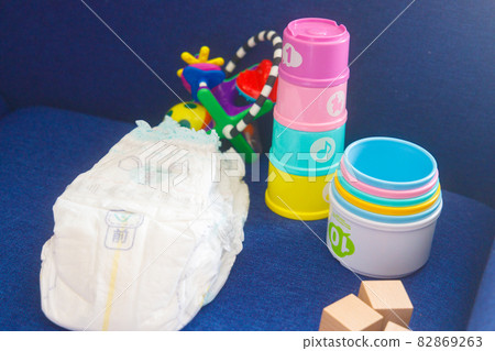 Baby diapers and toys on the sofa Baby diapers and toys on the sofa 82869263