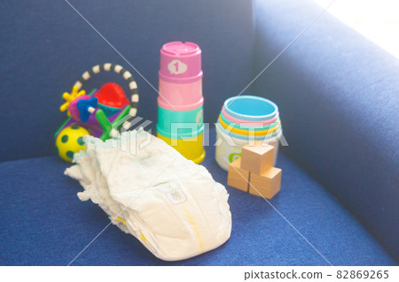 Baby diapers and toys on the sofa Baby diapers and toys on the sofa 82869265