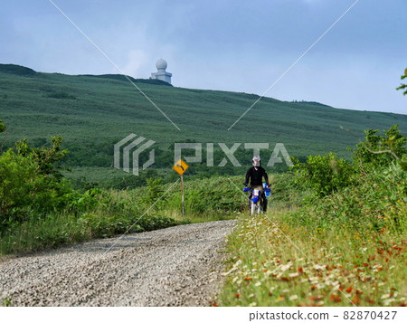A motorcycle running on a forest road with a superb view 82870427