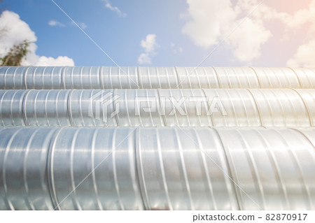 Ventilation pipes against the blue sky. Steel pipes, parts for the construction of air ducts for an 82870917
