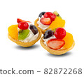 fruit and berry tart dessert with toss sugar on wooden background. Fresh delicious sweet cake with raspberries, grapes, strawberries, cherry, kiwi, grapefruit and cream. 82872268