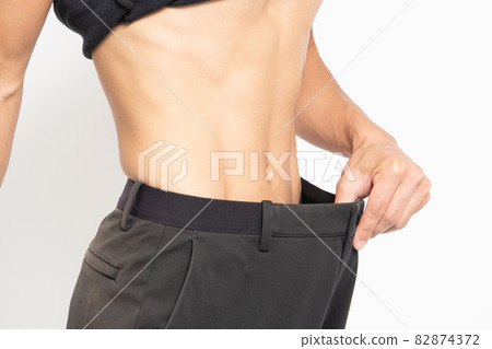 Belly of a man standing in front of a white background Belly of a man standing in front of a white background 82874372