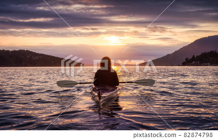 Adventurous Woman on Sea Kayak paddling in the Pacific Ocean. 82874798