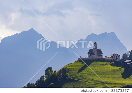 Mountainous landscape with villages of Colle Santa Lucia with church in Dolomites, South Tyrol, Italy Mountainous landscape with villages of Colle Santa Lucia with church in Dolomites, South Tyrol, Italy 82875277