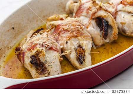 chicken rolls stuffed with dry tomatoes in bacon 82875884