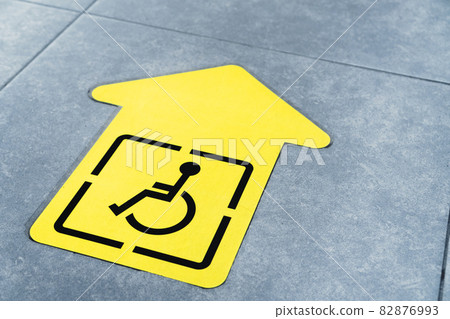 Yellow arrow for the disabled on the floor of the waiting room Yellow arrow for the disabled on the floor of the waiting room 82876993