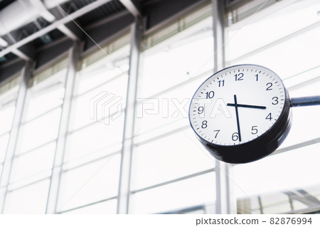 The arrow clock in the airport terminal on the background of windows 82876994