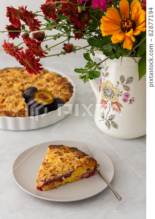 A piece of plum cake on a plate 82877194