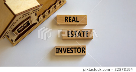 Real estate investor symbol. Wooden blocks with words 'Real estate investor' near miniature house. Beautiful white background. Business and real estate investor concept, copy space. Real estate investor symbol. Wooden blocks with words 'Real estate investor' near miniature house. Beautiful white background. Business and real estate investor concept, copy space. 82878194