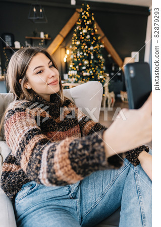 Young caucasian woman using laptop computer in holidays at home in the armchair in living room..Young caucasian woman using laptop computer in holidays at home in the armchair in living room. Young caucasian woman using laptop computer in holidays at home in the armchair in living room..Young caucasian woman using laptop computer in holidays at home in the armchair in living room. 82879293