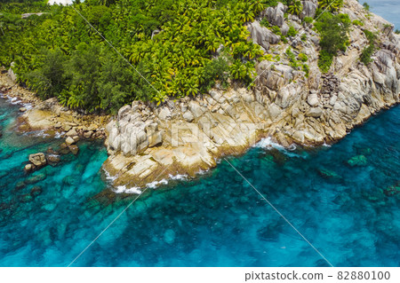 Aerial drone helicopter view of crystal clear turquoise water and amazing granite rocks. La Digue Island Seychelles Aerial drone helicopter view of crystal clear turquoise water and amazing granite rocks. La Digue Island Seychelles 82880100