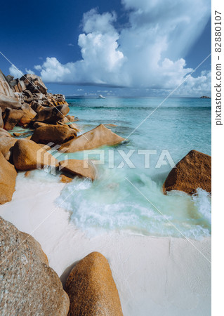 Beautifully shaped granite boulders and blue lagoon at Grand Anse beach, La Digue island, Seychelles Beautifully shaped granite boulders and blue lagoon at Grand Anse beach, La Digue island, Seychelles 82880107