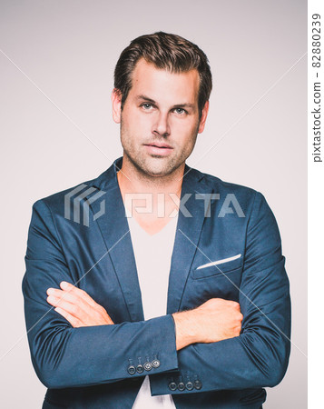 Portrait of a smart young man standing with arms crossed. Portrait of a smart young man standing with arms crossed. 82880239
