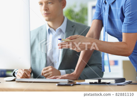 Young man communicates with colleague and is studying business strategies on computer closeup Young man communicates with colleague and is studying business strategies on computer closeup 82881110