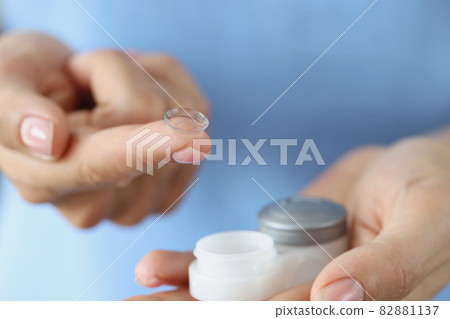 Soft contact lens on finger and storage box closeup Soft contact lens on finger and storage box closeup 82881137