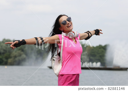 Portrait of happy smiling woman in sunglasses on background of fountain Portrait of happy smiling woman in sunglasses on background of fountain 82881146
