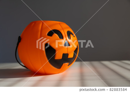 A basket for sweets in the shape of a pumpkin jack on a lantern on a white background. 82883584