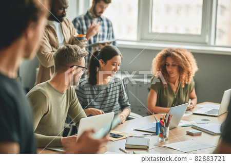 Young colleagues working together on some work tasks 82883721