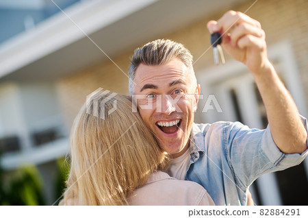 Emotional shining man with key and wife back Emotional shining man with key and wife back 82884291