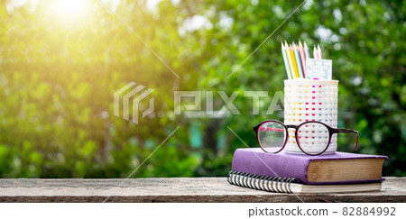 Back to school background with books, pencil and ruler on green blurred backgrounds with copy space. Back to school background with books, pencil and ruler on green blurred backgrounds with copy space. 82884992
