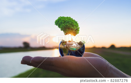 Nature globe on hand with sunrise Nature globe on hand with sunrise 82887276