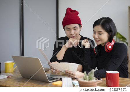 Team of creative graphic designer working on new project in office. Team of creative graphic designer working on new project in office. 82887571