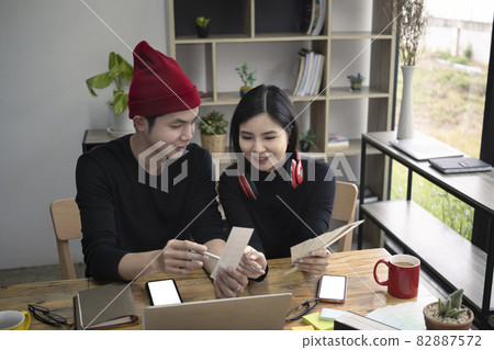 Two creative designer discussing ideas and working together in office. Two creative designer discussing ideas and working together in office. 82887572