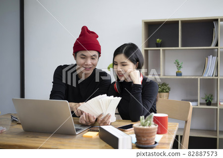 Two young graphic designer working together in creative office. 82887573