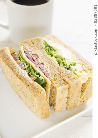 Delicious breakfast pastrami beef sandwich, cheese potato sandwich and hot coffee 82887591