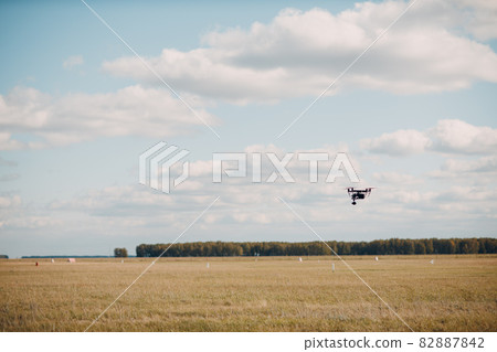 Big quadcopter drone on aerial flight and filming Big quadcopter drone on aerial flight and filming 82887842
