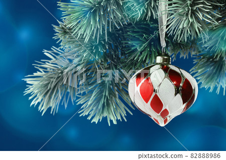 Christmas ornaments. Red and white bauble on blue background Christmas ornaments. Red and white bauble on blue background 82888986