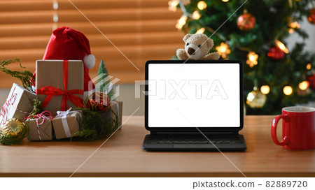 Digital tablet, cup of coffee and Christmas presents on wooden table. Digital tablet, cup of coffee and Christmas presents on wooden table. 82889720